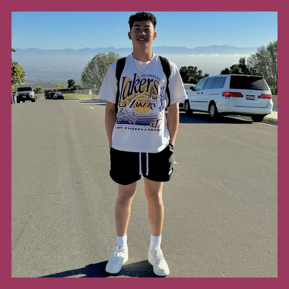 Sei standing in the street and smiling