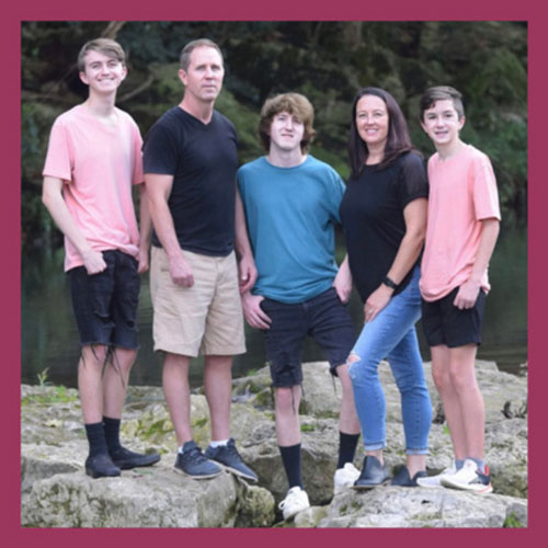 David standing with his family
