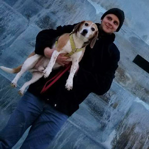 Joe standing holding his dog