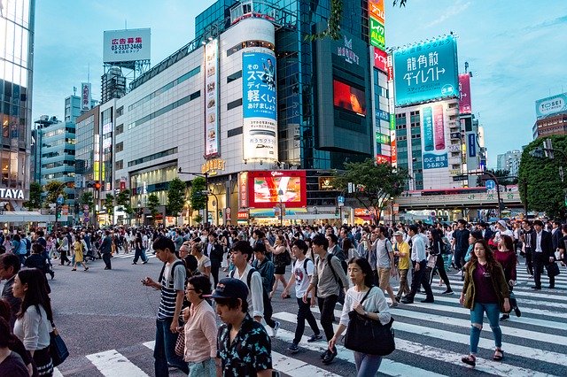 People crossing street in city in Japan