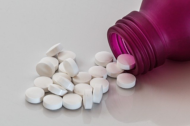 Pills spilling from bottle
